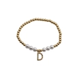 Detail of beaded bracelet with gold beads, pearls and colorful zircon letter D charm - Letter D