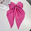 Large fuchsia satin bow hair clip with long ribbons on a white background - Lotus Pink