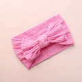 Detailed view of soft pink nylon baby headband featuring a large jacquard knit bow - Water Pink