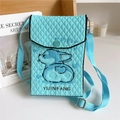 Close-up of light blue knitted crossbody bag featuring diamond quilted texture and dog pattern - Corgi Cyan