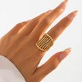 Modern gold rectangular ring with openwork vertical stripes shown on a model hand - 03 Light Gold Vertical Striped