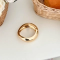 Polished gold irregular chunky bangle with hinge closure on minimalist background - Rounded Irregular Hinged Bangle (SL333) / Gold