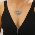 Detail of silver floral necklace with long tassel and snake chain on model - Necklace (06)