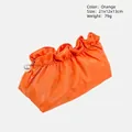 Ruched orange cosmetic bag with glossy finish and pearl charm zipper detail - Orange