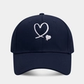 Detailed view of dual heart embroidery on navy cotton twill baseball cap with stitching - Adjustable / Navy Blue