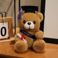 Brown graduation teddy bear with black cap and blue tassel holding a diploma - Deep Blue Sash Style / Dark Brown