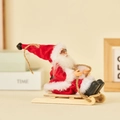 Plush Santa Claus figure on a miniature wooden sleigh with rope and bell decoration - Sled Style (Classic Red)