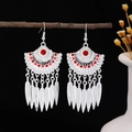 Bohemian silver earrings with red stone accents and feather tassel drops - Red