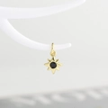 Detail of a gold eight-pointed star pendant with a centered black zircon stone - Gold with Black Zirconia