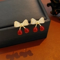 Detail of cherry bow earrings featuring 18K gold plating and sparkling white zircon stones - 18K Gold Plated Red Cherry Bow Style (Silver Pin)