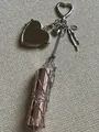 Detail of silver mesh lipstick holder keychain featuring a heart mirror and bow charm - Heart Clasp With Mirror Tassel Mesh Bag / Zinc Alloy Heart Style