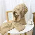 Detailed close-up of thick light camel knitted scarf hood with warm fleece lining texture - Beige