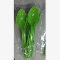 Green plastic party spoons for dinosaur birthday set on a light wood background - 16Pcs Dinosaur Spoons