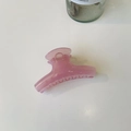 Detail view of large pink translucent hair claw clip with smooth round non-slip teeth - Medium-8cm / Jelly Pink