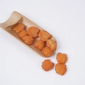Artificial orange resin walnut sculptures displayed in a bamboo spoon for home decor - Caramel Walnut Kernels (500g)