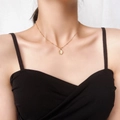 Elegant 18k gold plated stainless steel necklace with oval opal pendant on a model - White Cat's Eye Stone