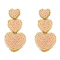 Detailed close-up of three-tier peach pink seed bead heart earrings with gold trim - Pink