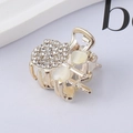 Macro shot of gold mini hair claw clip with white rhinestones and heart cat-eye stones - 5# Rhinestone Set Small Claw Clip
