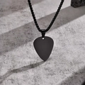 Close-up of a black guitar pick pendant necklace on a grey textured concrete background - Guitar Pick Shape / Black