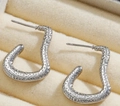 Close-up of silver irregular J-shaped earrings with hammer-textured metal surface - Silver Style K7-103