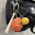 Orange baseball glove keychain with wooden bat and ball accessory on black sports bag - 2CM Yellow Ball Long Bat Orange