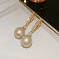 Elegant gold earrings with sparkling crystals and large round pearls in a jewelry box - Gold Zirconia Pearl Style (HE20671) / Champagne