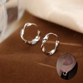 Silver Mobius hoop earrings with a twisted wave design and smooth metallic luster - Irregular Wave Design / White Gold