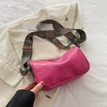 Pink PU leather Boston bag with colorful wide strap displayed on a beige blazer - Rose Pink