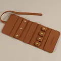 Brown microfiber jewelry roll organizer featuring earring holders and snap button straps - Brown