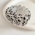 Detail of a wide leopard print resin stretch bracelet with textured animal patterns - White