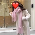 Outdoor winter scene of a thick pink mohair tassel scarf worn with a white coat - Mohair Solid Pink Small Version