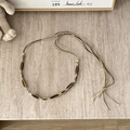 Close-up of bohemian woven belt with amber-like beads and cream rope on stone background - Coffee Slender Bead Patchwork - 135cm