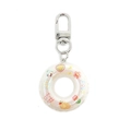 Macro detail of holographic mini swim ring keychain with colorful duck and flower motifs - White