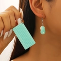 Close-up of mint green 3D mini keyboard and mouse earrings worn by a model - Mint Green