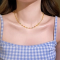 Close-up of a delicate gold chain necklace featuring colorful zircon flower accents on a model - Colorful Zirconia Flower Style / Gold Multicolor