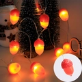 Close-up of warm glowing acorn LED string lights wrapped around a mini Christmas tree - 2m 10LEDs (Battery) / New Acorn