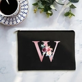 Black canvas cosmetic bag featuring a floral pink letter W with gold zipper closure - Letter W