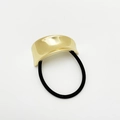 Detailed view of glossy gold zinc alloy metal hair cuff with black elastic tie cord - Polished Gold