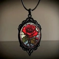 Macro shot of Gothic necklace featuring a red rose pendant inside a black filigree frame - 30*40 Rose