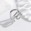 Macro shot of adjustable silver multi-layer winding ring on white textured stone - Layered Intertwined Hollow Silver Ring (EH819)