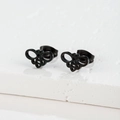 Macro shot of black hollow bee stud earrings on a textured white plaster block - Bee Style (159) / Black