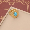 Macro detail of golden bohemian ring with teardrop turquoise and radial sunburst texture - Style 4: Ring
