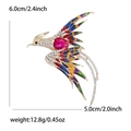 Elegant gold phoenix brooch with colorful enamel and pink crystal on white background - Colorful