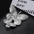 Macro shot of elegant silver butterfly hair clip with metallic finish on black surface - Large Silver (1pc)