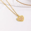 Macro view of a gold plated heart pendant with embedded pearls on a fine bead chain - Pearl Inlay Heart Necklace / Gold