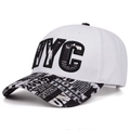 Detail of white NYC snapback cap showing embroidery and graffiti print flat brim - White