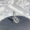 Detail of silver snake ring with a colorful iridescent gemstone on a black stone base - Style 1 Adjustable Ring