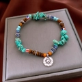 Detail of vintage beaded bracelet with sun totem pendant on a grey jewelry box - Irregular Multi-Material Beaded (Bracelet-Blue-Coffee-Irregular)