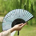 Classic Chinese folding fan with blue floral pattern, black bamboo ribs and silk tassel - Magnolia Bird Black Handle