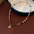 Macro detail of 18k gold plated necklace featuring tiger eye beads and turquoise pendant - 19# Oval Tiger Eye Resin Pendant Necklace